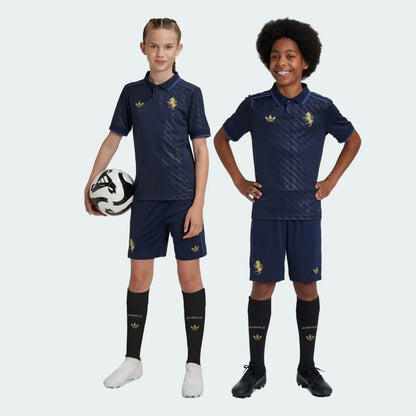 Duas crianças vestindo o kit infantil da Juventus em azul marinho com detalhes e escudo em dourado.