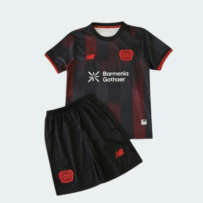 Kit infantil preto e vermelho do Bayer Leverkusen com camisa de listras verticais, escudo do clube e shorts combinando. Logos visíveis.