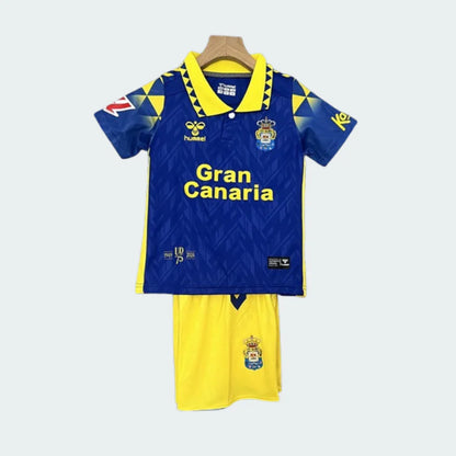 Kit infantil de futebol do Las Palmas com camisa azul-royal e detalhes amarelos, e shorts amarelos.