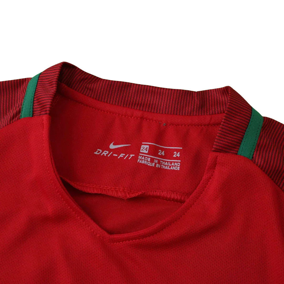 Detalhe da gola interna de camisa infantil vermelha com listras, logo Nike Dri-Fit e etiqueta de fabricação da Tailândia.