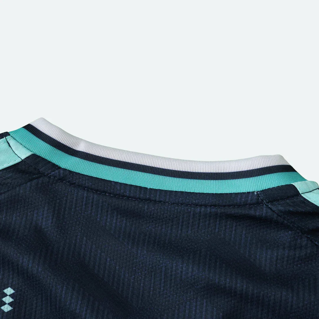 Detalhe da gola e parte superior das costas de uma camisa esportiva azul marinho texturizada.