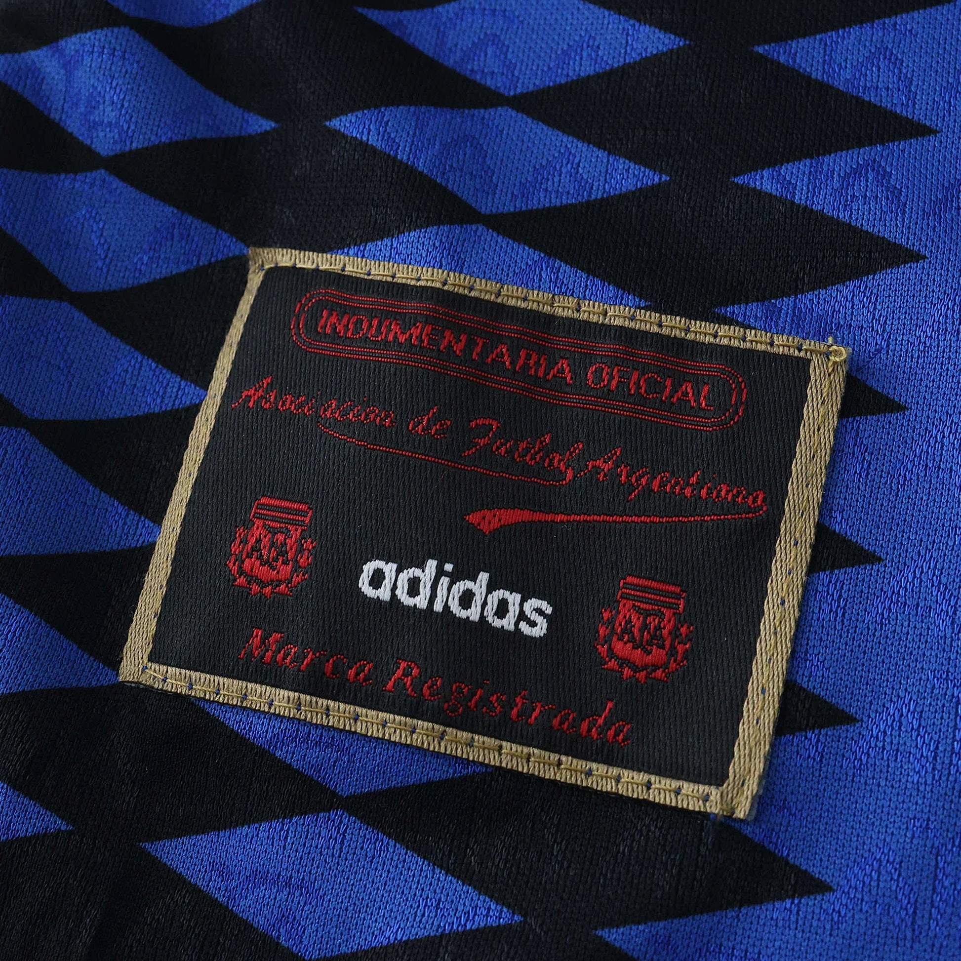 Tag oficial da camisa kit Argentina infantil adidas Mini Mantos, cores azul e preta