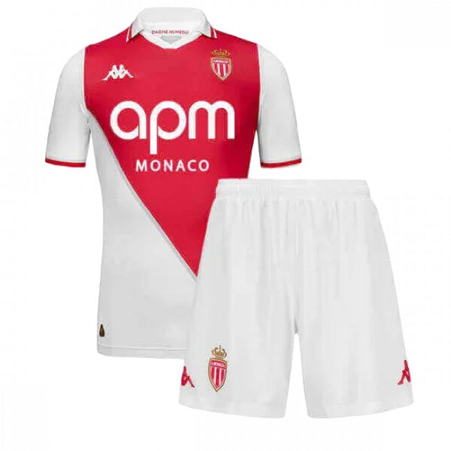 Kit infantil do Mônaco 24/25, camisa branca e vermelha com design diagonal, escudo do time e shorts brancos com escudo.